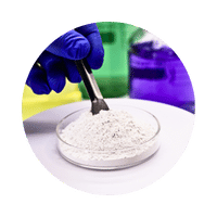 Gloved hand handling white powder in petri dish with colorful lab containers."